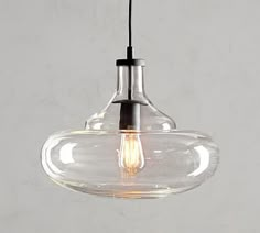 a clear glass light fixture hanging from a ceiling