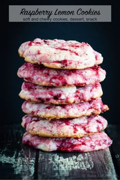 a stack of cookies covered in powdered sugar and crumbled with pink icing