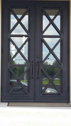 two double doors with decorative iron work on them