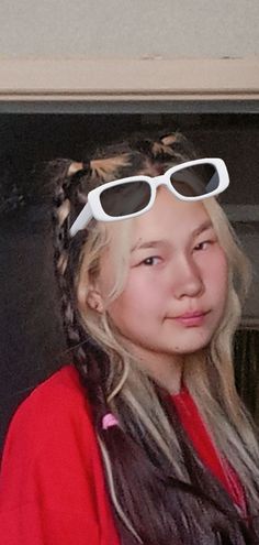 a girl with long hair and sunglasses on her head