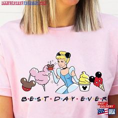 a woman wearing a pink shirt with the words best day ever and an image of a cartoon character