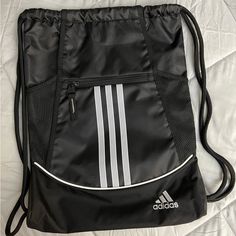 Brand New, Never Been Used, Black Adidas Drawstring Backpack With White Stripes And Zippered Pocket. Adidas Backpack, Adidas Bags, Grey Backpacks, Nike Acg Jacket, Nike Air Max Tn, Nike Sweater, Vintage Beaded Dress, Long Sleeve Blouse Pattern, Light Blue Sweater