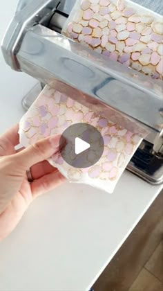 someone is using a machine to cut paper