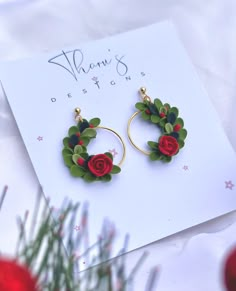 Drop Length: 1.6 in. Colors: Dark Green, Light Green & Red Background: Green Earring Hardware: Polymer Clay, Gold Plated Rings  Each pair of our floral earrings are based on nature and intricately designed to inspire. Each pair is hand-sculpted from premium clay and designed to pair with any outfit. If you are into pretty things, these earrings are calling your name! ITEM CARE: Please note these are not designed to be exposed to water for long periods of time. Please keep away from oils, lotions and perfumes. *Keep in mind that all computer monitors display colors differently, so your earring may differ slightly in color from the image you see onscreen. Xmas Polymer Clay, Christmas Earrings Polymer Clay, Winter Polymer Clay, Xmas Clay, Polymer Clay Christmas Earrings, Christmas Polymer Clay Earrings, Clay Christmas Earrings, Christmas Wreath Earrings, Fimo Ring