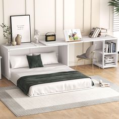 a white bed sitting on top of a hard wood floor next to a desk and chair