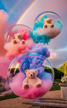 two teddy bears sitting on top of soap bubbles in the shape of clouds and rainbows