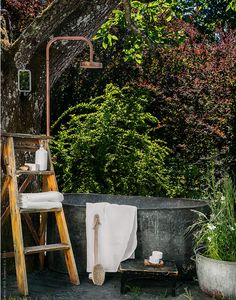 a wooden ladder sitting next to a bath tub