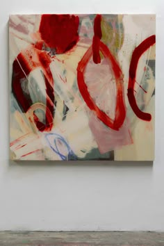 an abstract painting on the wall with red and white paint in it's center