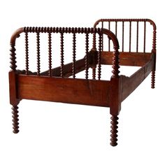 an old wooden bed frame with wood slats