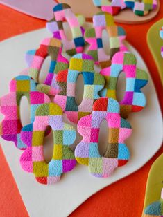 colorful decorated cookies sitting on top of a white plate