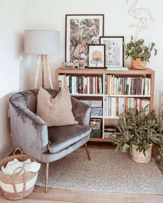 a living room filled with furniture and bookshelves next to a lamp on a table