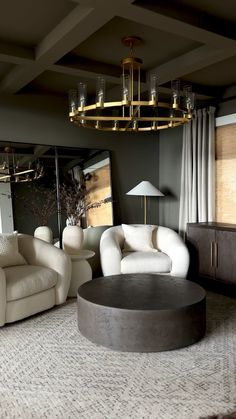 a living room filled with furniture and a chandelier