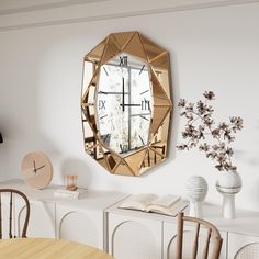 a mirror that is on the wall above a table