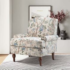 a living room with a striped rug and floral chair