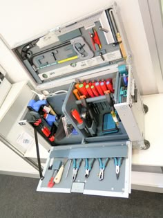 an open tool box filled with tools on top of a table