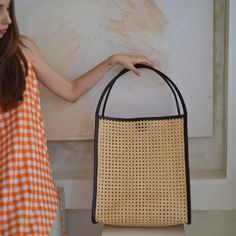 This simple and sleek, oversize and spacious rattan cane and leather trim tote with a unique shape is perfect for those on-the-go who want to carry in chic style.  Continue our slow-made and made by demand approach. Each bag is handmade with love by our skilled artisans with fine-quality leather and rattan.  Plastic free packaging. Handmade in Bali.  Color: Dark Brown leather trim. Wipe clean with a damp cloth. Material: Rattan Cane and Leather trim. Rattan Cane, Eco Luxury, Laptop Tote Bag, Vegan Leather Bag, Market Bag, Dark Brown Leather, Woven Bag, Luxury Gifts, Gift Accessories