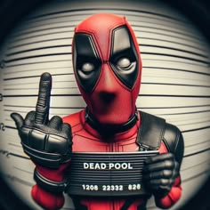 a deadpool man holding a sign in his hand