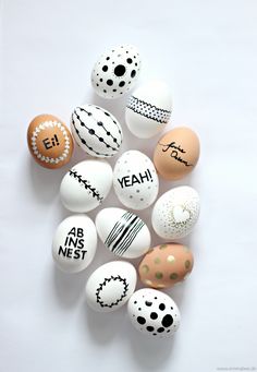 an assortment of decorated eggs with words written on them