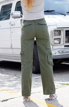 Take on any adventure in the super comfy Green Kim Cargo Pants from John Galt. These ultra-cool pants have cargo pockets throughout, a drawstring waistband, and a full-length relaxed leg.


	Solid color pants
	Rigid fabric
	Low-rise
	Cargo pockets
	Drawstring waistband
	Zip fly closure
	Relaxed fit
	65% cotton, 35% polyester
	Fits size 23" - 25" waist
	Model measurements: 5’8” height, 34” bust, 25” waist, 36” hip Womens Green Cargo Pants, Cargo Pants For Teen Girls, Green Techwear, Cute Cargo Pants Outfits, Fitted Cargo Pants, Dark Green Cargo Pants, Green Cargo Jeans, Kim Cargo Pants, Cute Cargo Pants