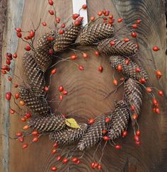 a wreath made out of pine cones and berries