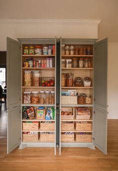 an open pantry with two doors and shelves full of food