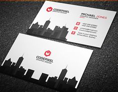 two business cards with the city skyline in red and white