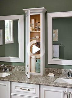 a bathroom with double sinks and two medicine cabinets in the middle, one is open