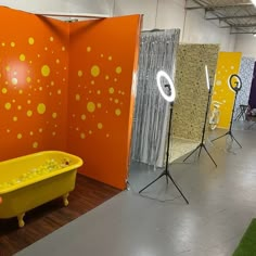 there is a yellow tub in the middle of this room with orange and yellow walls