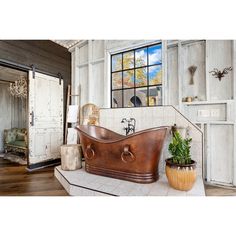 an old fashioned bathtub in the middle of a room