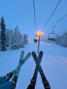 two skiers are standing in the snow with their skis on and one person is holding up some ski poles