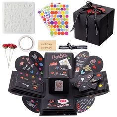 the contents of a black gift box with hearts and confetti on it are shown