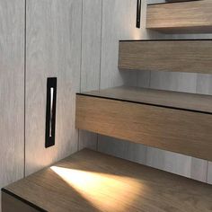 the stairs are made of wood and have black handles