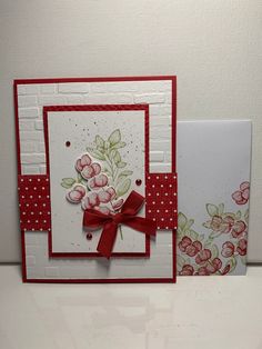 two cards, one with red ribbon and the other with pink flowers