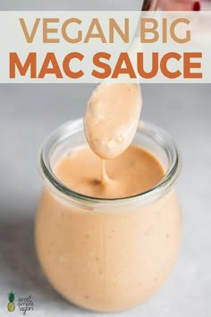 a spoon full of vegan bbq mac sauce in a jar with the title above it