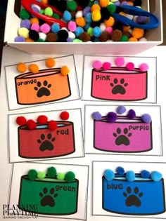 this is an image of a box with different colored pom poms in it