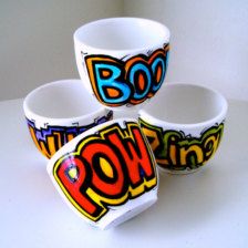 four cups with the word boo on them are stacked up in a pyramid shape and have been painted onto