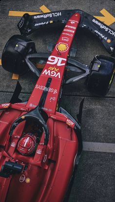 a red race car sits on the ground