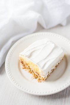 a piece of cake sitting on top of a white plate next to a fork and napkin