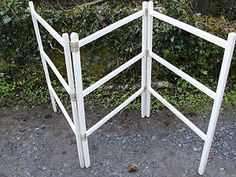 a white wooden fence sitting on top of a gravel ground