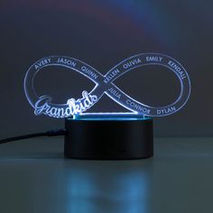 an illuminated lamp with the name of two people and their names on it, in front of a dark background