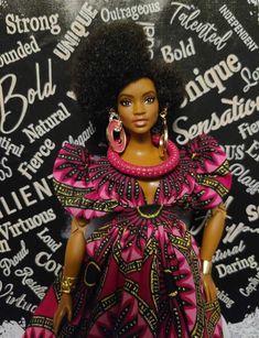 a barbie doll wearing a pink and black dress with large hoop earrings on it's head