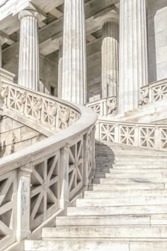 the stairs are made of stone and have columns on each side that lead up to them