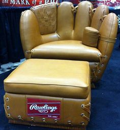 a tan leather chair and footstool are on display