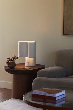 a table with two lamps on it next to a couch