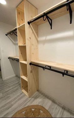 an empty room with wooden shelves and black metal brackets on the wall, along with carpeted flooring