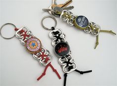 two key chains with different types of keys attached to them, one has a bottle opener and the other is a pair of scissors