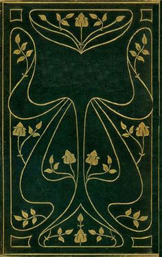 an old book with gold and green designs on the front cover, featuring leaves and flowers