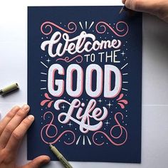 someone is drawing on a card that says welcome to the good life with some crayons