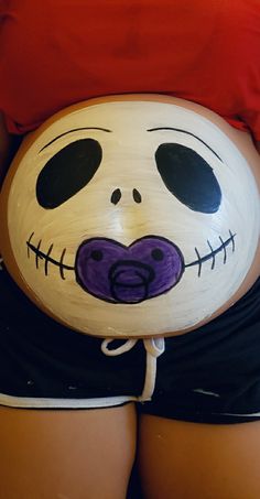 a pregnant belly with a skeleton painted on it