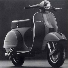 an old vespa scooter is shown in this black and white photo